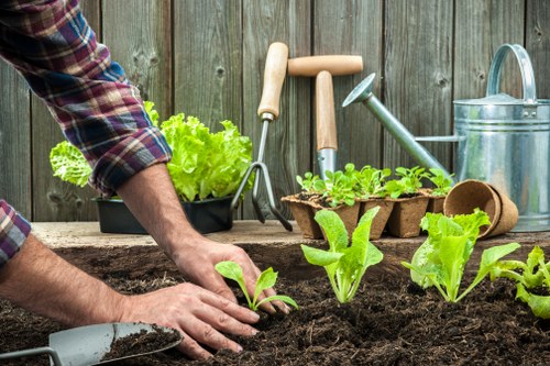 Gardener in Enfield Town working safely with protective equipment